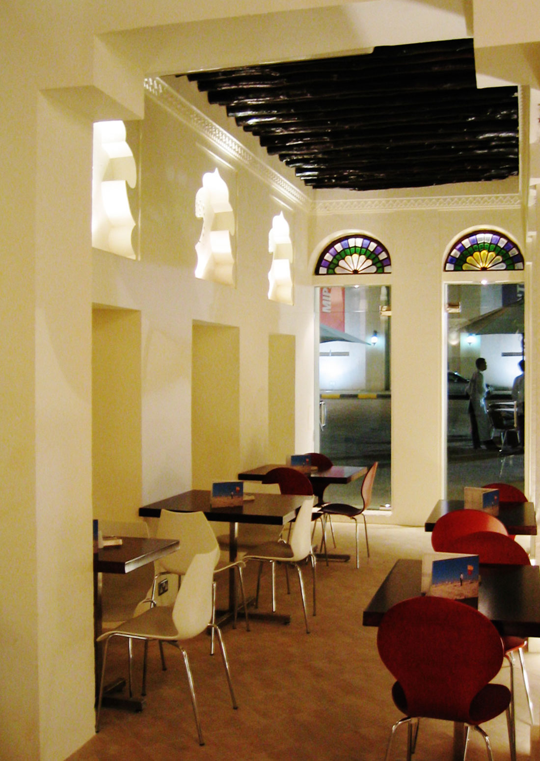 Blind niches were opened and replaced by glazing to allow a view out of the Fen Cafe in Sharjah by RTAE, Dubai